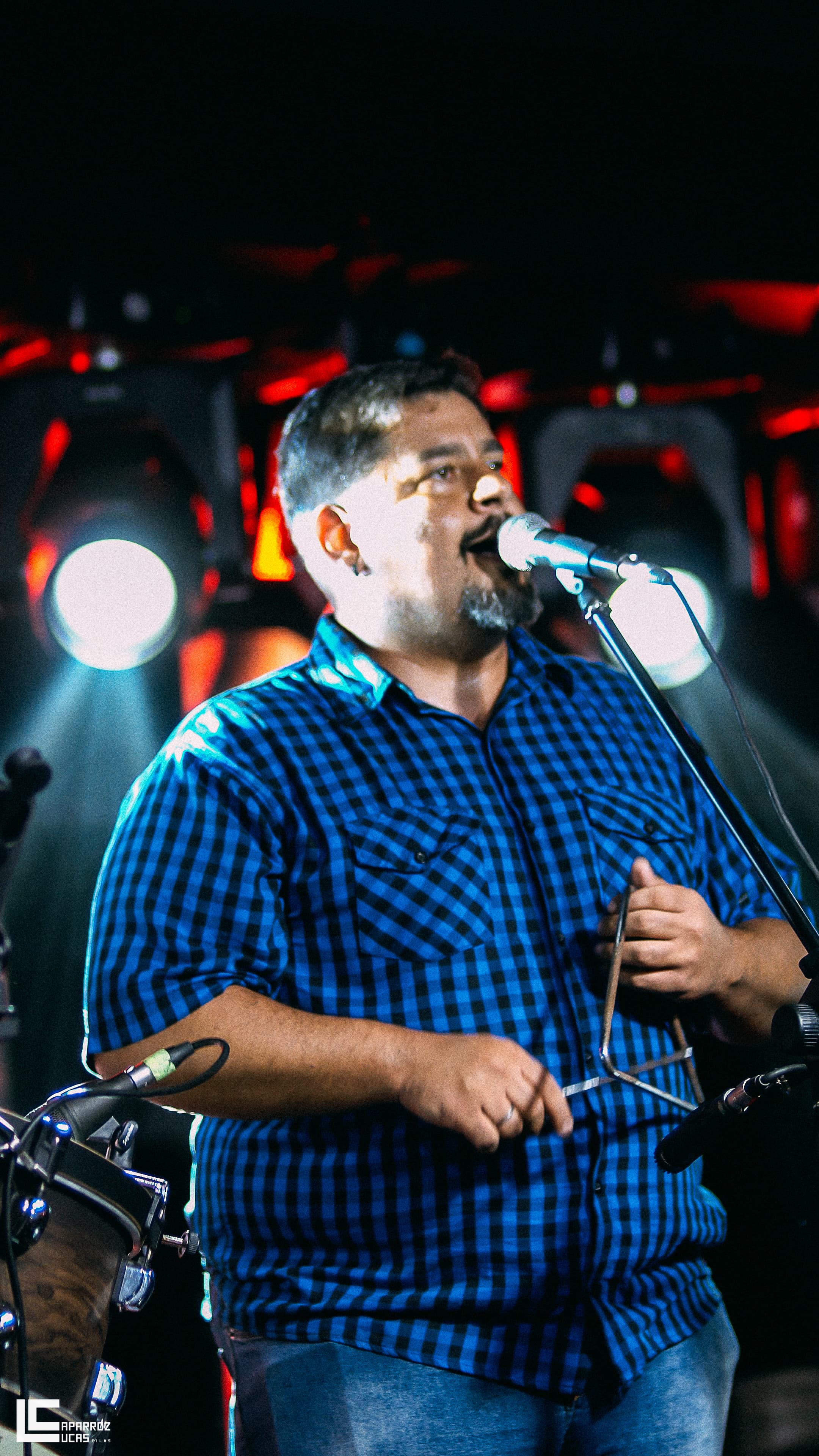 Lucas cantando e tocando zabumba no palco